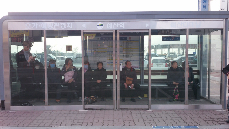 발열의자가 설치된 버스승강장에서 버스를 기다리는 모습